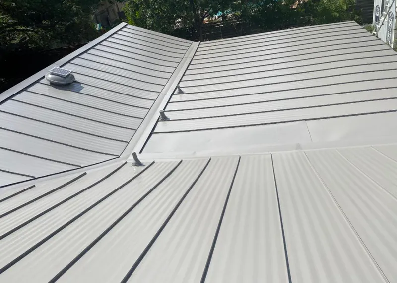 Solar attic fan installed on a metal roof for Roof Ventilation in Langley Park