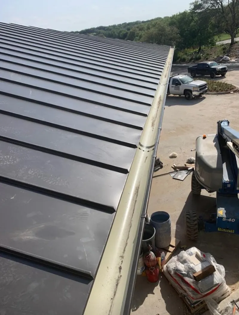 Standing seam panel and gutter detail on a metal roofing jobsite in Langley Park